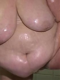 Fat granny shows her hairy bush while taking a shower
