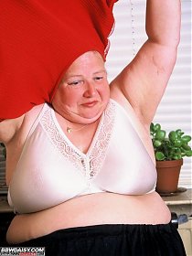 An obese amateur woman fooling around with her vegetables
